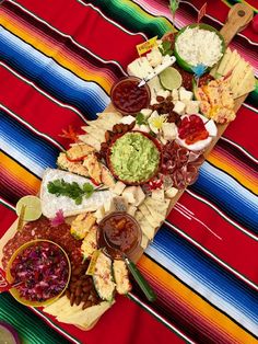 a colorful table cloth with food on it