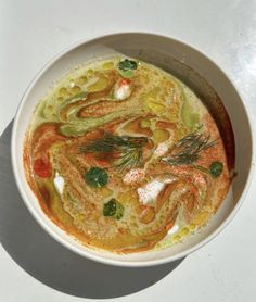 a white bowl filled with soup on top of a table