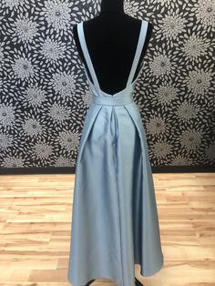 This satin dress with a high neck and low back is casual yet sophisticated. This gown is a size 12. The measurements are: Bust-38.5, Waist-30.5, and Hip-40.5. Please see our Sizing Section for questions on how to measure. This gown is a sample and may show signs of shop-wear. For a full list of what shop-wear may include please click here and see question number 2. Satin Dress With Pleated Back For Prom, Fitted Satin Dress With Back Opening, Satin Gown With Pleated Back For Prom, Satin Gown With Pleated Back For Prom Season, Floor-length Satin Gown With Pleated Back, Satin Party Gown With Pleated Back, Satin Gown With Back Opening For Prom Season, Floor-length Satin Dress With Back Opening For Prom, Formal Satin Gown With Pleated Back