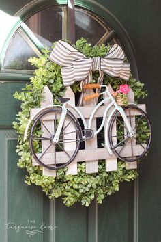 a bicycle is mounted to the front door with bow ties on it's handlebars