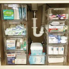 an organized bathroom drawer with clear drawers and lots of toiletries in the bins