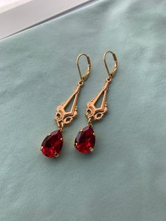 "RED Pear Edwardian Earrings in Swarovski Ruby or Scarlet Red Stones on 16k gold plated lever backs Long gold chandelier Edwardian earrings Pictures 1-3: SCARLET, Pictures 4-8: RUBY RED I do have some RUBY RED back in stock while supplies last! Ruby Red is a darker Red and slightly cooler tones, while Scarlet is a warm Red. This listing is for a pair of lovely reproduction Edwardian/Titanic style earrings. Gorgeous gold Edwardian chandeliers with RUBY RED or SCARLET RED Swarovski PEAR stones set Red Teardrop Chandelier Earrings For Formal Occasions, Elegant Red Teardrop Chandelier Earrings, Red Dangle Chandelier Earrings For Anniversary, Red Chandelier Earrings For Anniversary, Elegant Red Teardrop Earrings With Ear Wire, Elegant Gold Crystal Earrings With French Hook, Red Dangle Jewelry With French Hook, Gold Ruby Chandelier Earrings As Gift, Edwardian Earrings