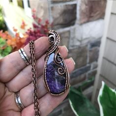 A stunning purple charoite with splashes of black and wisps of white to create a beautiful mix of colors. This pendant measures 2 1/2 x 1 inch wide.  Textured curves adorn the top and swirls cascade down one side.   Twisted wire adds sparkle. The copper has been oxidized (darkened) and polished for an antique look.  See my shop for all of my handmade jewelry  www.etsy.com/shop/moonletjewelry Bohemian Copper Crystal Necklaces With Natural Stones, Bohemian Crystal Necklaces With Natural Stones In Copper, Mystical Purple Jewelry With Natural Stones, Artisan Amethyst Wire Wrapped Jewelry, Artisan Purple Wire Wrapped Jewelry, Handmade Purple Copper Wire Necklace, Bohemian Lavender Crystal Gemstone Necklace, Bohemian Lavender Gemstone Crystal Necklace, Handmade Purple Necklace With Copper Wire