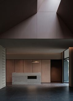 an empty room with wooden cabinets and a skylight