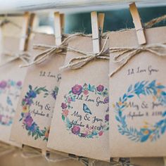 wedding favors are hanging on clothes pins