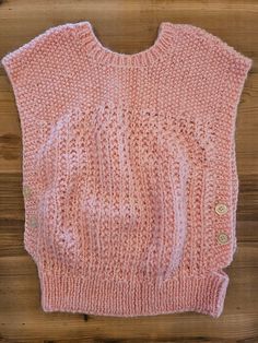 Small baby pink vest Button side closures Rounded collar Acrylic cable knit Measurements: 19 inches long 18 inches wide 7 inch shoulder width  Ships with tracking and insurance Pink Knitted Sleeveless Top, Pink Sleeveless Knitted Top, Pink Hand Knitted Knit Tops, Pink Knit Tops With Buttons, Pink Knit Sweater Vest, Pink Knit Top With Buttons, Pink Hand Knitted Tops, Vest Knitted, Baby Rosa