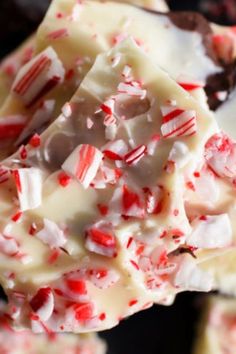 white chocolate with peppermint and candy canes on top is being held by a spoon