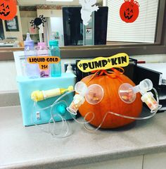 an orange pumpkin with goggles and mouthpieces sitting on top of a counter