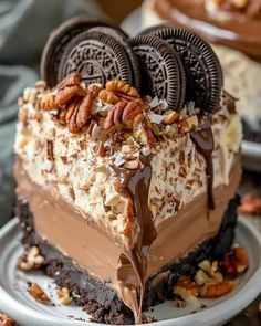 there is a piece of cake with chocolate and pecans on the top, topped with oreo cookies