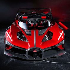 a red and black sports car is shown in this artistic photo with its hood open