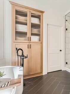 GO to the link to see this full bathroom renovation. This white oak linen closet doubled in size and is the perfect place to display towels and toiletries to give the master bathroom a spa feel. The shower was converted into a steam shower and a perfect way to unwind at the end of the day. Tall Cabinet In Bathroom Master Bath, Bathroom Tall Cabinet Organization, Inset Linen Cabinet, Primary Bathroom Storage Ideas, Bathroom Linen Cabinet Ideas, Linen Cabinet In Bathroom Built Ins, Built In Cabinets Bathroom, Bathroom Connected To Closet, Master Bath Closet