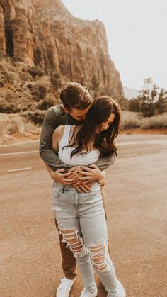 a man and woman hugging in the desert