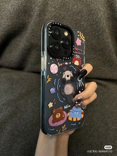 someone holding up their phone case with an image of a bear and other animals on it