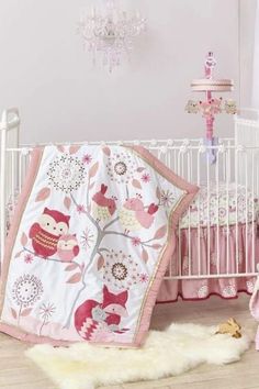 a baby crib with pink and white decor