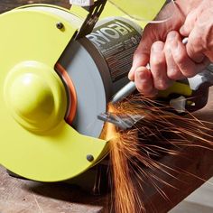 a person using a grinder to cut metal