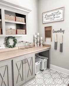 a white and gray laundry room with lots of storage