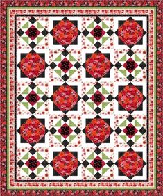 a red and black quilt with flowers on it