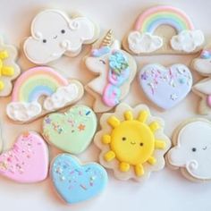 a bunch of decorated cookies sitting on top of a white table next to each other