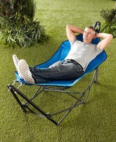 a man laying in a lawn chair on the grass