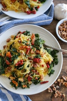 two white plates filled with pasta and vegetables