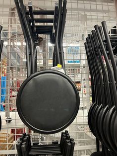 there are many black chairs in the store and one has a round object on it