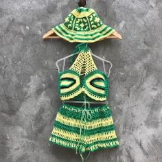 Rasta 3 piece crochet outfit Halter crop top, shorts and panama hat matching set Granny square crochet set woman Beach festival gift her Material: cotton, microfiber Colour: yellow, green and black Size: choose in variations! Pretty festival 3 piece rasta crochet outfit for woman. In this handmade unique outfit you will be unforgettable! Size chart women XS: Chest: 32.3"/ 82 cm Waist: 24.4"/ 62 cm Hips: 35.4"/ 90 cm S: Chest: 33.9"/ 86 cm Waist: 26"/ 66 cm Hips: 37"/ 94 cm M: Chest: 35.4"/ 90 cm Waist: 27.5"/ 70 cm Hips: 38.6"/ 98 cm L: Chest: 37.8"/ 96 cm Waist: 30"/ 76 cm Hips: 41"/ 104 cm XL: Chest: 40.15"/ 102 cm Waist: 32.3"/ 82 cm Hips: 43.3"/ 110 cm For more crochet outfits for women's, click here: https://www.etsy.com/shop/Garust?ref=seller-platform-mcnav&section_id=35266619 Garust Handmade Green Swimwear For Vacation, Summer Beach Two-piece Crop Top, Two-piece Crop Top For Summer Vacation, Summer Vacation Two-piece Crop Top, Green Two-piece Set For Vacation, Bohemian Fitted Beach Sets, Green Two-piece Vacation Set, Crochet Shorts For Beach Season, Crochet Beach Shorts For Beach Season