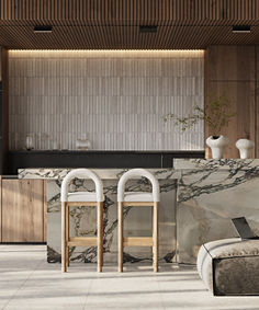 a kitchen with marble counter tops and stools