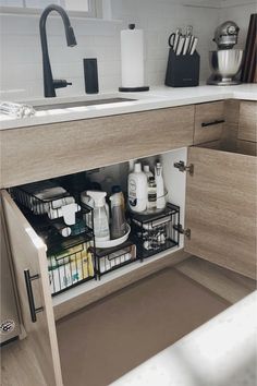 an open cabinet in a kitchen with dishes and utensils