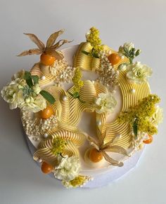 there is a cake decorated with flowers and fruit on the top, as well as other decorations