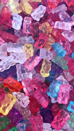 many different colored gummy bears are scattered together