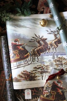 the wrapping paper is decorated with santa's sleigh and reindeers