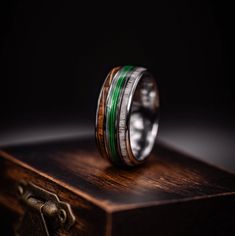 Fishing line wedding ring featuring antler and whiskey barrel wood on a wooden box. Unique outdoorsman jewelry. Traditional Wedding Bands, Fishing Wedding, Antler Ring, Unique Symbols, Cushion Ring, Outdoor Enthusiast, Whiskey Barrel, Ring Stand, Fishing Line