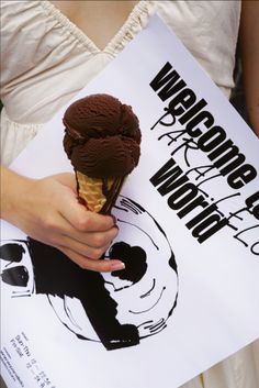 a woman holding an ice cream cone in her hand and a sign with the words wrapper witch on it