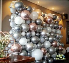 a bunch of balloons that are in the shape of a pyramid on top of a table