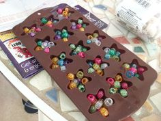 there is a chocolate tray with small beads on it