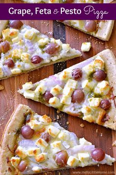 three slices of pizza with cheese, olives and feta on them sitting on a wooden cutting board