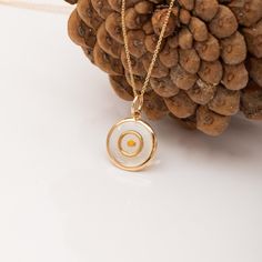 ✨ This elegant pendant necklace features a unique "circle within a circle" design, symbolizing unity, spiritual growth, and wholeness. Crafted in your choice of 14k or 18k solid gold and available in yellow, rose, or white gold, the pendant encases a mustard seed in laser enamel. The mustard seed represents faith, while the circle symbolizes the infinite growth of one's spirit and belief. Perfect for those seeking a meaningful piece of Christian jewelry.  🔹 Key Details: Gold Karat: Available 14k and 18k solid gold Gold Color: Yellow, rose, or white gold Material: Genuine mustard seed encased in laser enamel Pendant Diameter: 12mm Chain width: Available in 0.72mm, 0.84mm and 0.95mm Necklace Lengths: 14, 16, 18, 20, or 22 inches Please note, due to handwork, the size may vary slightly. 🎁 P Amulet Style Circular Jewelry Gift, White Necklace With Charms And Round Pendant, Circle Shaped Amulet Jewelry As Gift, White Coin Pendant Jewelry, Circle Charm Necklace In Yellow Gold For Gift, White Medallion Necklace With Coin Pendant, White Coin Pendant Jewelry As Gift, White Coin Pendant Jewelry For Gift, White Medallion Coin Pendant Necklace