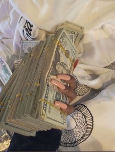 a person holding stacks of money in their hands