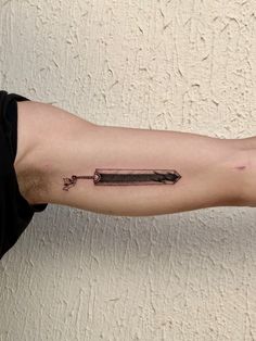 a man's arm with an arrow tattoo on it