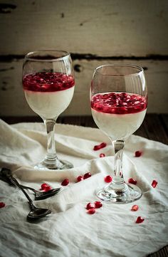 two wine glasses filled with red and white liquid