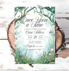 a wooden slice with the words once upon a time on it and flowers in the background