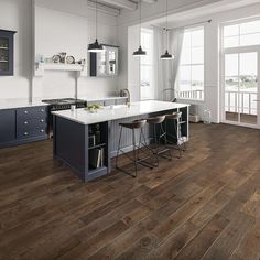 a large kitchen with wooden floors and white walls