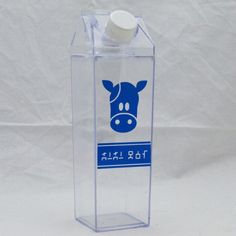 a bottle with a toothbrush in it sitting inside of a clear box on a white background