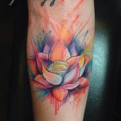 a colorful flower tattoo on the arm