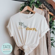 a t - shirt that says happy golden days on it next to some sweaters