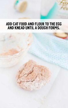 a cookie is sitting on a table next to an empty glass bowl and napkin with the words add cat food and flour to the egg and knead until dough forms