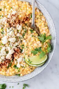 a bowl filled with corn and garnished with cilantro