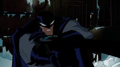 batman in the dark knight animated movie, looking at his cell phone while standing on snow covered ground