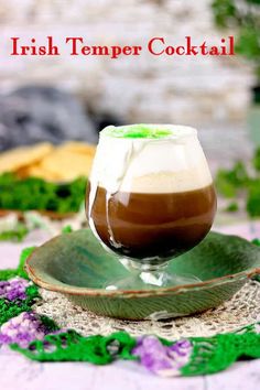 there is a drink that is sitting on a green saucer with the words irish temper cocktail