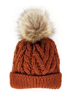 an orange knitted hat with a fur pom - pom on the top